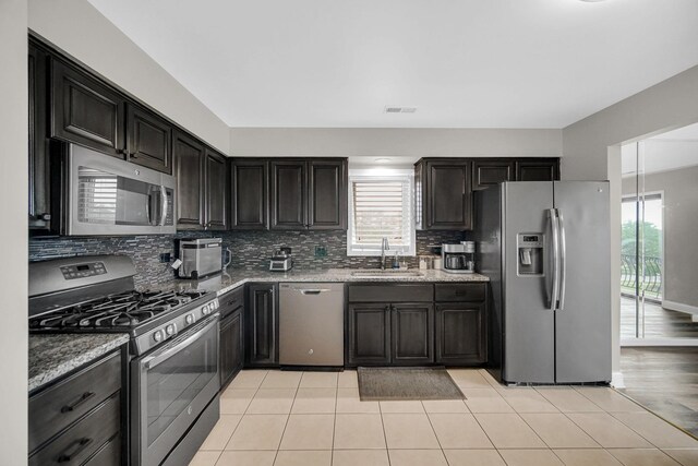 17824 Bernard Dr Unit 3D, Orland Park, IL 60467 - kitchen with appliances with stainless steel finishes, plenty of natural light, backsplash, and light tile patterned floors