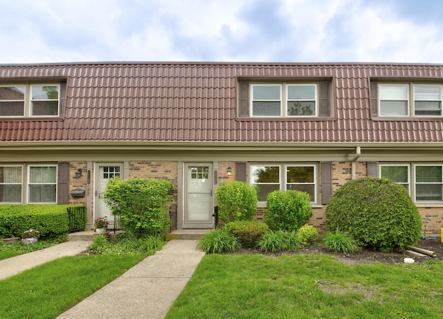 1770 Henley St Unit C, Glenview, IL 60025 - townhome / multi-family property featuring brick siding, a front yard, and a tile roof