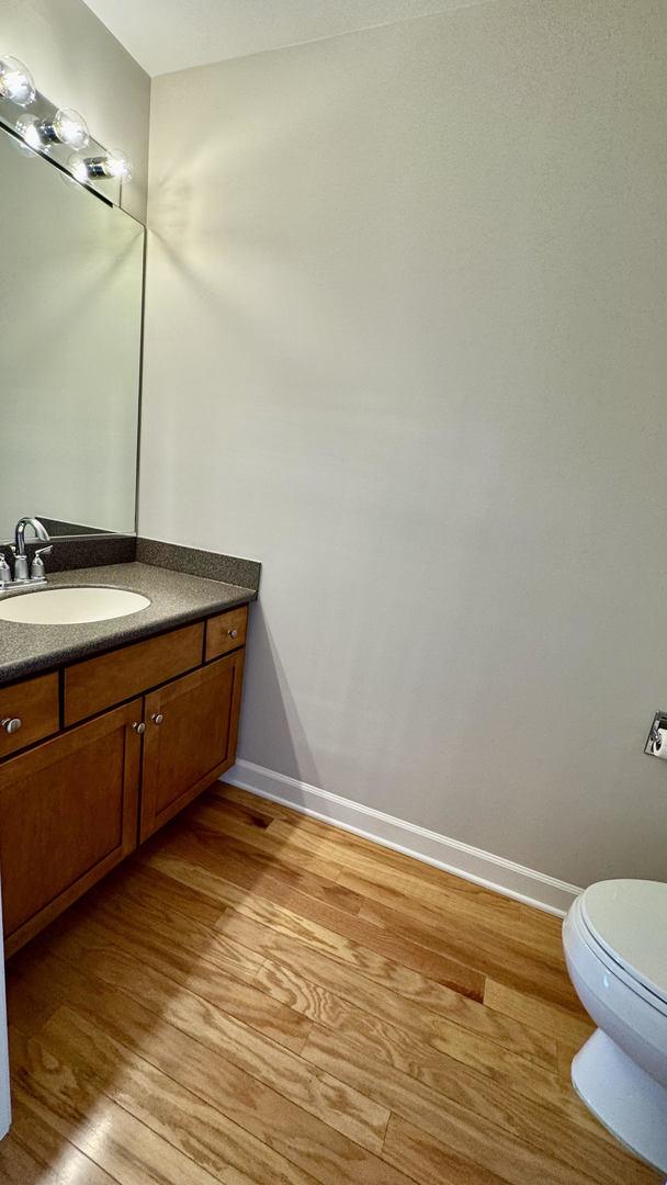 9360 Skokie Blvd Unit 414, Skokie, IL 60077 - half bathroom with wood finished floors and vanity