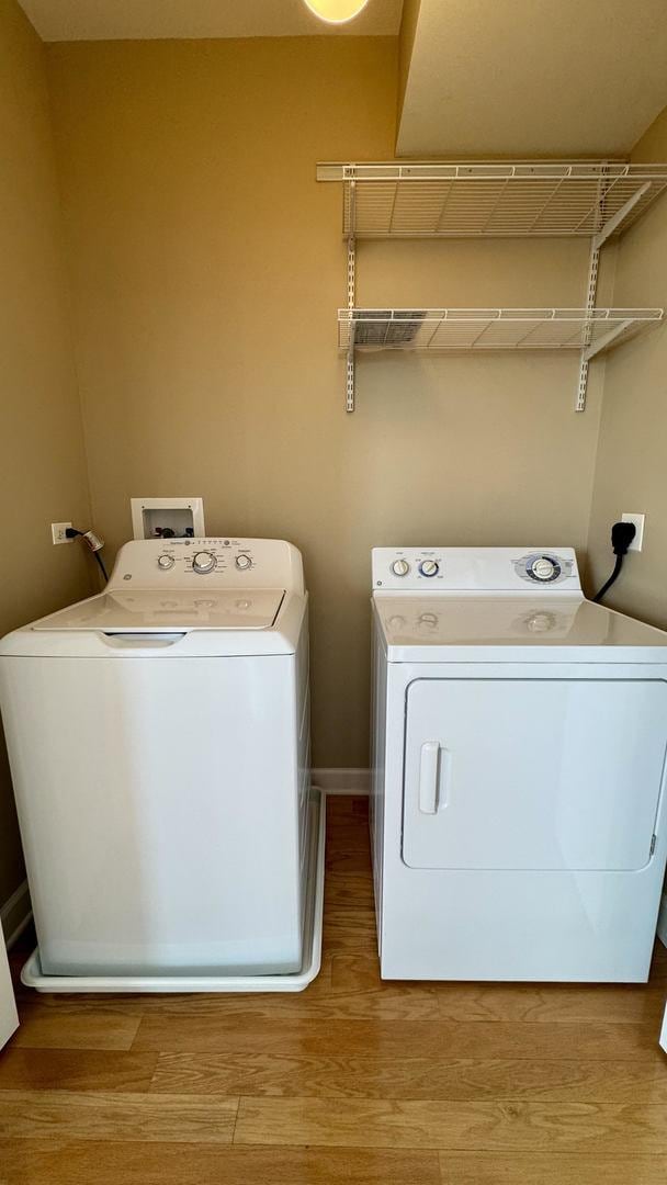 9360 Skokie Blvd Unit 414, Skokie, IL 60077 - washroom featuring washing machine and clothes dryer and wood finished floors