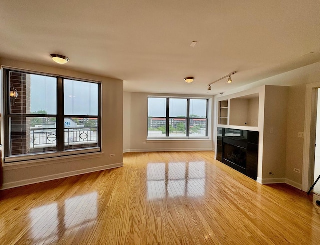 9360 Skokie Blvd Unit 414, Skokie, IL 60077 - unfurnished living room with light wood-style floors and a tile fireplace