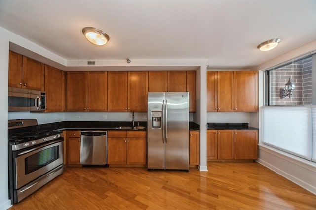 9360 Skokie Blvd Unit 414, Skokie, IL 60077 - kitchen featuring appliances with stainless steel finishes and brown cabinetry