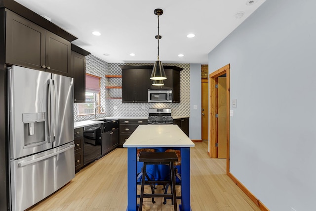 1225 W Greenleaf Ave Unit 3E, Chicago, IL 60626 - kitchen featuring stainless steel appliances, light wood-style flooring, open shelves, hanging light fixtures, and light stone countertops