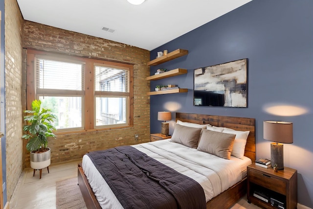 1225 W Greenleaf Ave Unit 3E, Chicago, IL 60626 - bedroom with brick wall, multiple windows, and wood finished floors