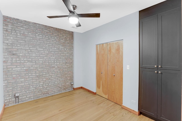 1225 W Greenleaf Ave Unit 3E, Chicago, IL 60626 - unfurnished bedroom with brick wall, light wood-type flooring, and ceiling fan