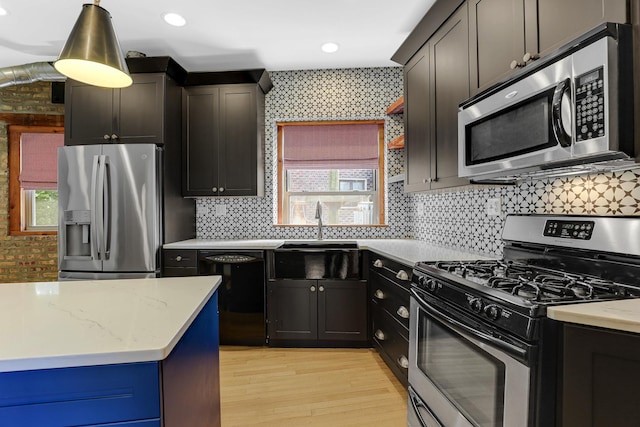 1225 W Greenleaf Ave Unit 3E, Chicago, IL 60626 - kitchen featuring appliances with stainless steel finishes, light wood-style floors, light stone counters, tasteful backsplash, and pendant lighting