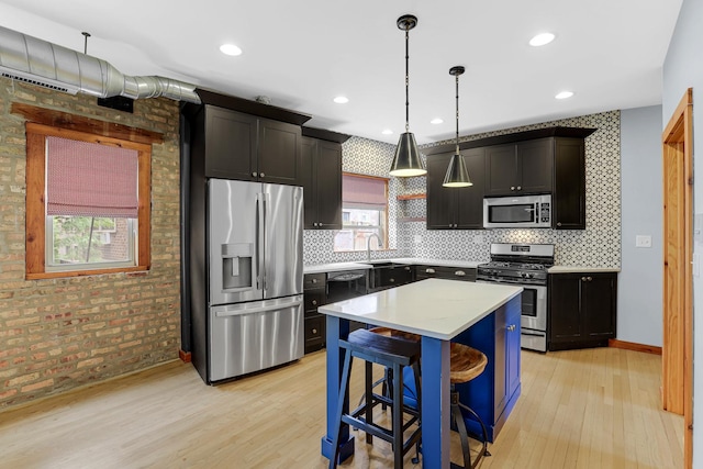 1225 W Greenleaf Ave Unit 3E, Chicago, IL 60626 - kitchen with stainless steel appliances, light wood finished floors, backsplash, light countertops, and a center island