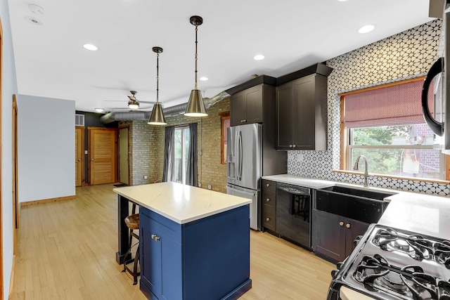 1225 W Greenleaf Ave Unit 3E, Chicago, IL 60626 - kitchen with black appliances, a kitchen island, light countertops, a kitchen bar, and light wood-style flooring