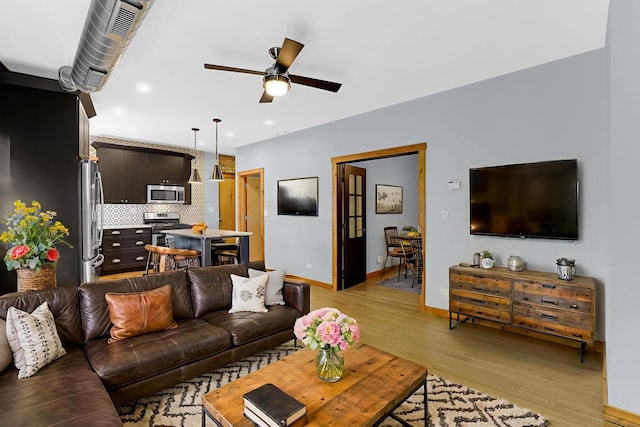 1225 W Greenleaf Ave Unit 3E, Chicago, IL 60626 - living room with light wood-style flooring, a ceiling fan, and recessed lighting