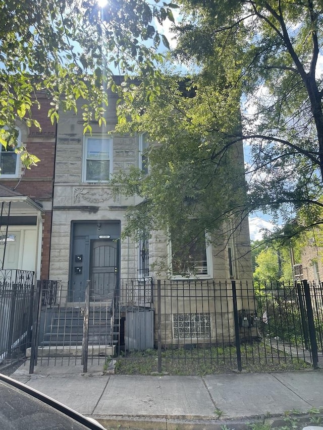 1528 S Spaulding Ave, Chicago, IL 60623 - view of front of home featuring stone siding and a fenced front yard