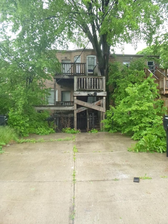 1528 S Spaulding Ave, Chicago, IL 60623 - view of front of home featuring stairs, brick siding, and a balcony