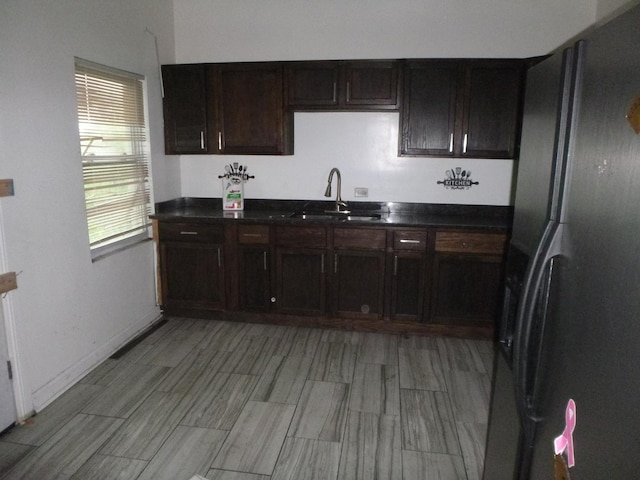1528 S Spaulding Ave, Chicago, IL 60623 - kitchen with refrigerator with ice dispenser, dark countertops, and dark brown cabinetry