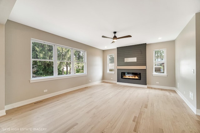 4947 Wilcox Ave, Downers Grove, IL 60515 - unfurnished living room featuring plenty of natural light, light wood-style flooring, a large fireplace, a ceiling fan, and recessed lighting