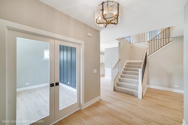 4947 Wilcox Ave, Downers Grove, IL 60515 - foyer with a chandelier, stairs, light wood-style flooring, and french doors