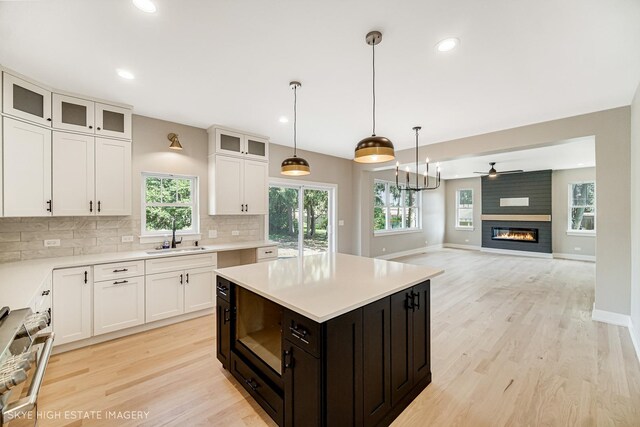 4947 Wilcox Ave, Downers Grove, IL 60515 - kitchen with light wood finished floors, white cabinetry, backsplash, light countertops, and recessed lighting