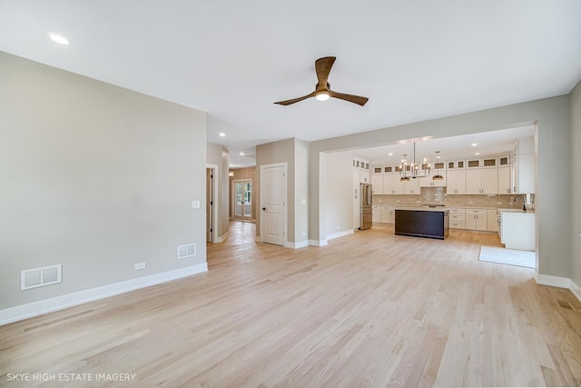 4947 Wilcox Ave, Downers Grove, IL 60515 - unfurnished living room with a chandelier, ceiling fan, light wood finished floors, and recessed lighting