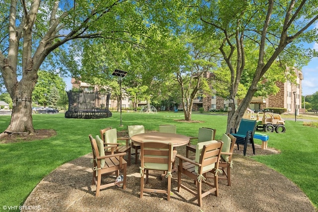 3300 N Carriageway Dr Unit 209, Arlington Heights, IL 60004 - view of patio featuring a trampoline and outdoor dining area