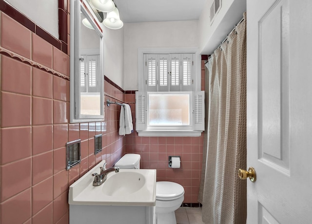 3355 N Neva Ave, Chicago, IL 60634 - bathroom featuring healthy amount of natural light, tile walls, vanity, tile patterned floors, and a shower with curtain