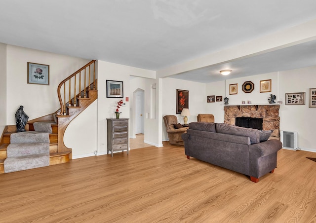 3355 N Neva Ave, Chicago, IL 60634 - living room with light wood-style floors, stairway, and a stone fireplace
