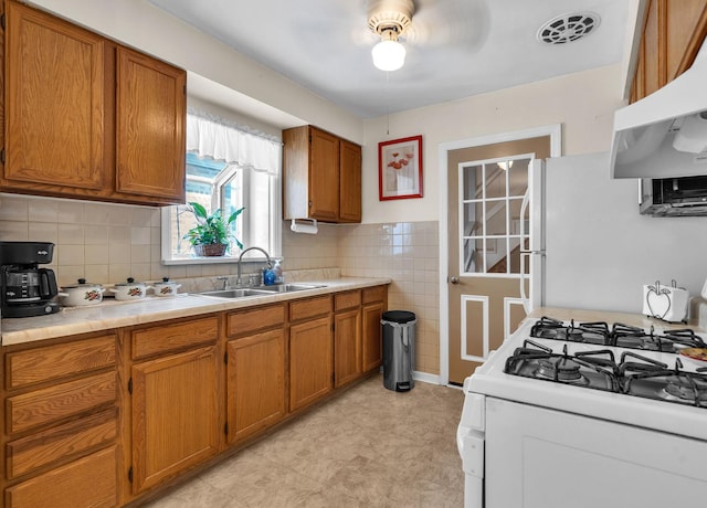 3355 N Neva Ave, Chicago, IL 60634 - kitchen with white appliances, ventilation hood, brown cabinets, and ceiling fan