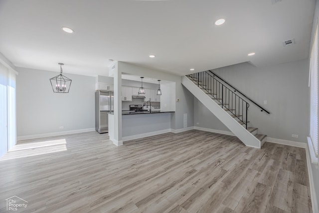 1594 Cornell Cir, Hoffman Estates, IL 60169 - unfurnished living room with a chandelier, stairway, light wood-style flooring, and recessed lighting