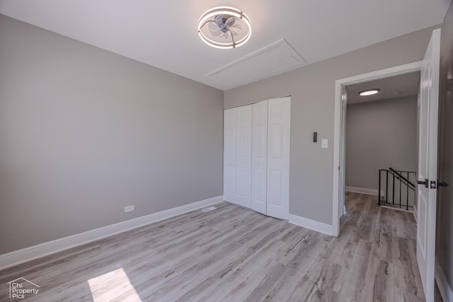 1594 Cornell Cir, Hoffman Estates, IL 60169 - unfurnished bedroom with attic access, light wood-style floors, and a closet