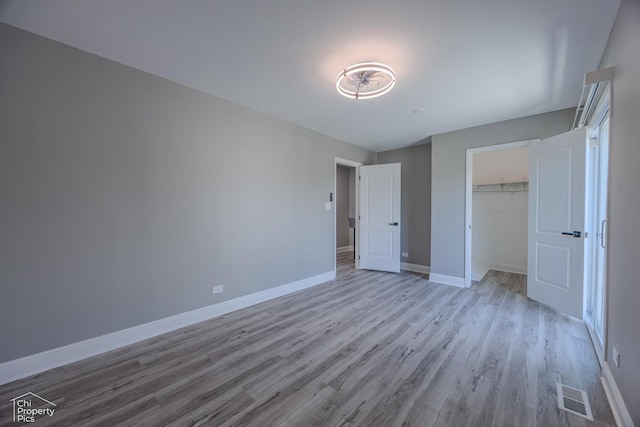 1594 Cornell Cir, Hoffman Estates, IL 60169 - unfurnished bedroom with wood finished floors and a closet