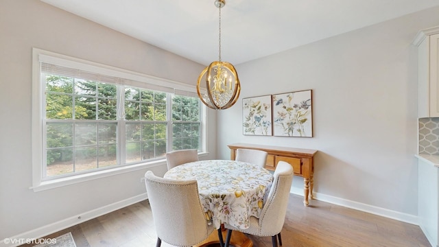 1517 128th St, Lemont, IL 60439 - dining area featuring light wood finished floors, healthy amount of natural light, and a chandelier