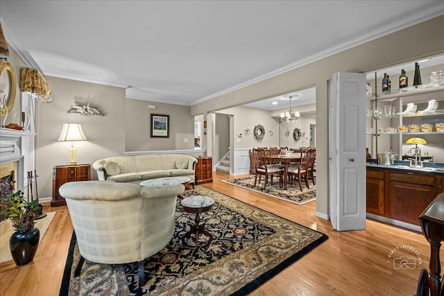 42W285 Retreat Ct Unit 2, Saint Charles, IL 60175 - living area featuring light wood-type flooring, crown molding, stairs, a chandelier, and a high end fireplace