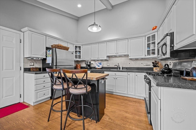 42W285 Retreat Ct Unit 2, Saint Charles, IL 60175 - kitchen with appliances with stainless steel finishes, backsplash, light wood-style flooring, white cabinetry, and a high ceiling