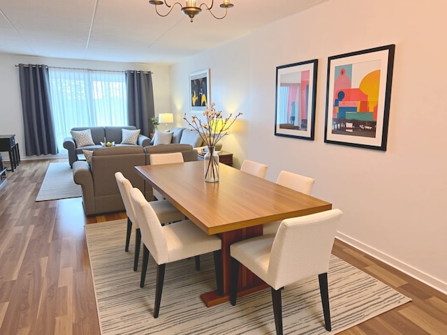 9386 Landings Ln Unit 306, Des Plaines, IL 60016 - dining room featuring a chandelier and wood finished floors