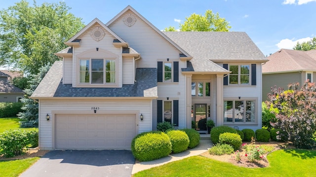 2845 Kendridge Ln, Aurora, IL 60502 - view of front of home featuring asphalt driveway, an attached garage, a shingled roof, and a front yard