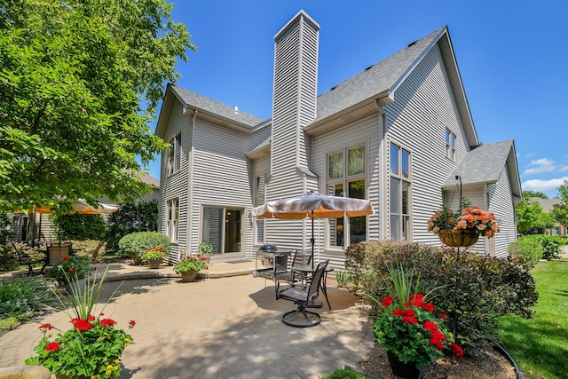 2845 Kendridge Ln, Aurora, IL 60502 - rear view of property featuring a chimney, a patio area, and roof with shingles