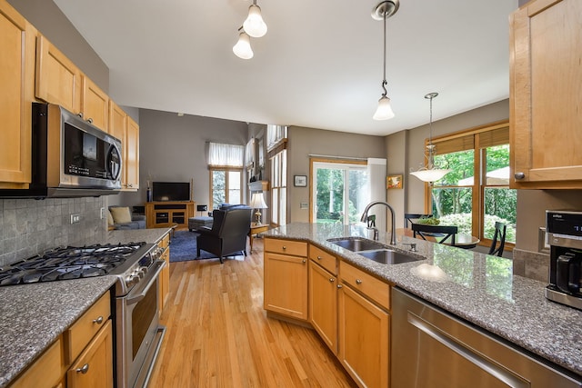 2845 Kendridge Ln, Aurora, IL 60502 - kitchen with stainless steel appliances, light wood finished floors, dark stone counters, backsplash, and pendant lighting