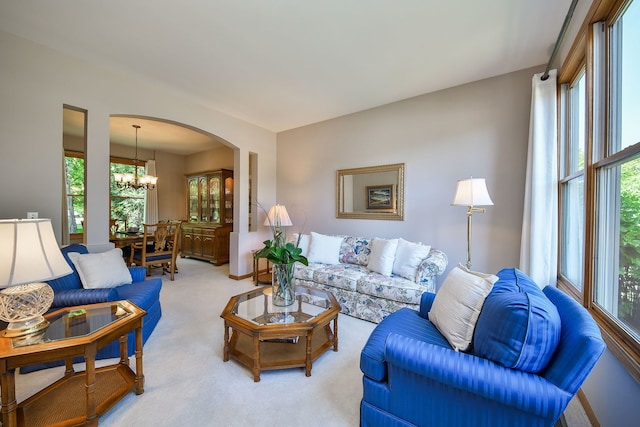 2845 Kendridge Ln, Aurora, IL 60502 - living room featuring arched walkways, a chandelier, and light carpet
