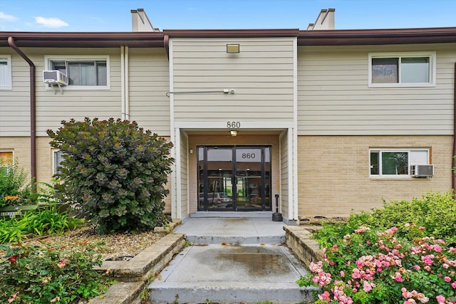 860 E Old Willow Rd Unit 228, Prospect Heights, IL 60070 - property entrance with brick siding and cooling unit