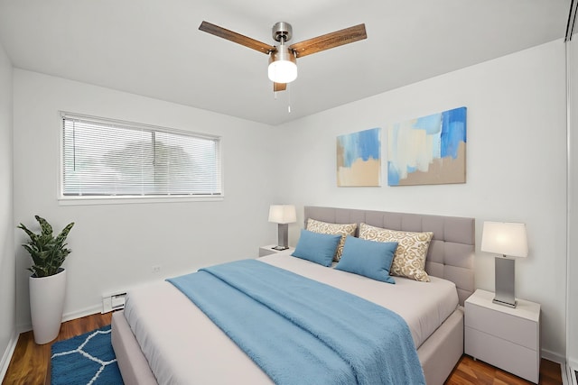 860 E Old Willow Rd Unit 228, Prospect Heights, IL 60070 - bedroom with a baseboard heating unit, wood finished floors, and a ceiling fan
