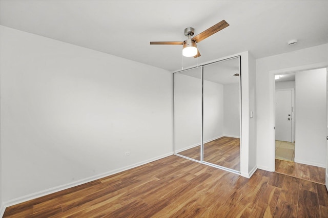 860 E Old Willow Rd Unit 228, Prospect Heights, IL 60070 - unfurnished bedroom featuring wood finished floors, a closet, and ceiling fan