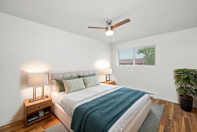860 E Old Willow Rd Unit 228, Prospect Heights, IL 60070 - bedroom with wood finished floors, a baseboard radiator, and a ceiling fan