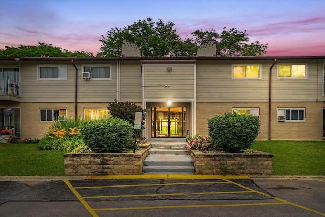 860 E Old Willow Rd Unit 228, Prospect Heights, IL 60070 - property at dusk featuring uncovered parking