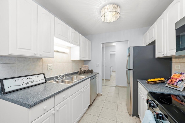 860 E Old Willow Rd Unit 228, Prospect Heights, IL 60070 - kitchen with stainless steel appliances, white cabinets, tasteful backsplash, light tile patterned floors, and dark countertops