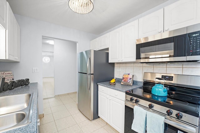860 E Old Willow Rd Unit 228, Prospect Heights, IL 60070 - kitchen with stainless steel appliances, decorative backsplash, and white cabinetry