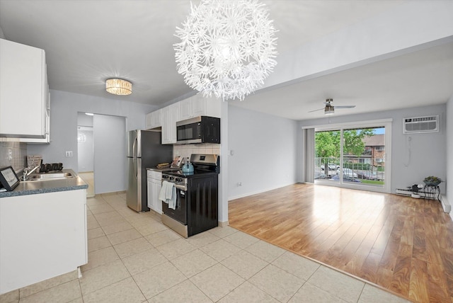 860 E Old Willow Rd Unit 228, Prospect Heights, IL 60070 - kitchen with appliances with stainless steel finishes, a wall mounted AC, white cabinets, backsplash, and ceiling fan