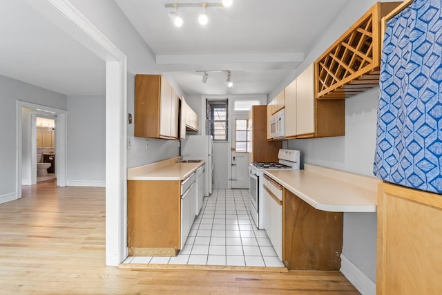 5455 S Ingleside Ave Unit 3E, Chicago, IL 60615 - kitchen with white appliances, rail lighting, light countertops, and light wood-type flooring