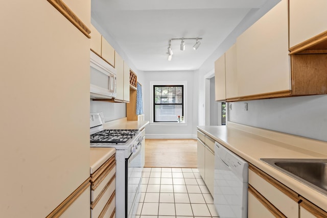 5455 S Ingleside Ave Unit 3E, Chicago, IL 60615 - kitchen featuring white appliances, light countertops, light tile patterned floors, and cream cabinets