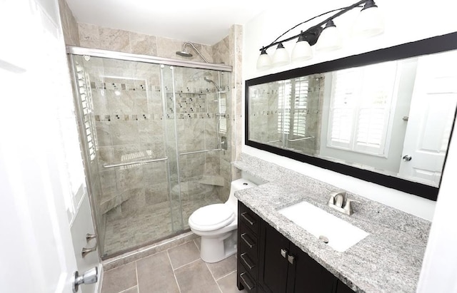 bathroom with vanity, a shower stall, and tile patterned floors