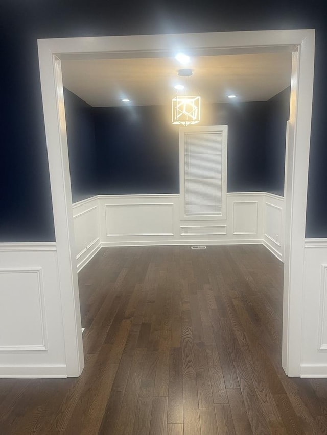 48 E 154th St, Harvey, IL 60426 - empty room with a wainscoted wall, wood finished floors, and a decorative wall