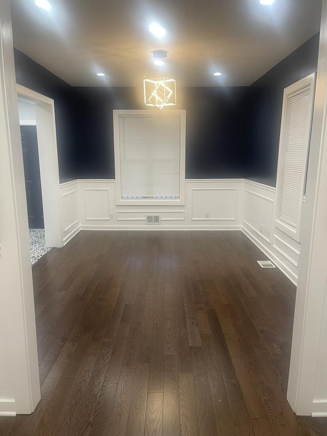 48 E 154th St, Harvey, IL 60426 - empty room with wainscoting, dark wood-style flooring, and a decorative wall