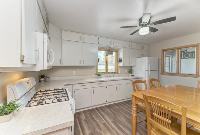 1617 Oakland Ave, Crest Hill, IL 60403 - kitchen featuring white appliances, light countertops, ceiling fan, wood finished floors, and white cabinetry