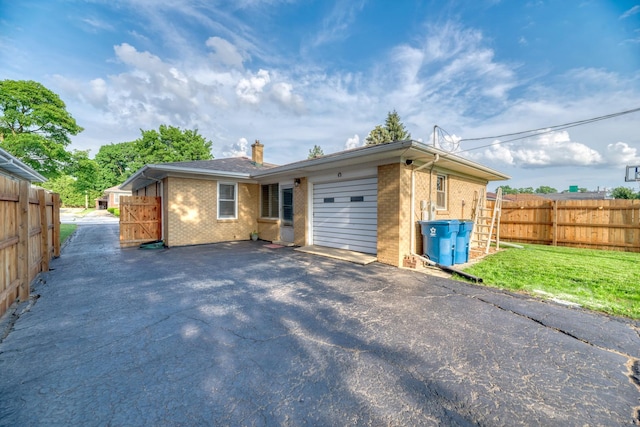 1617 Oakland Ave, Crest Hill, IL 60403 - view of front of house with brick siding, driveway, an attached garage, and a chimney